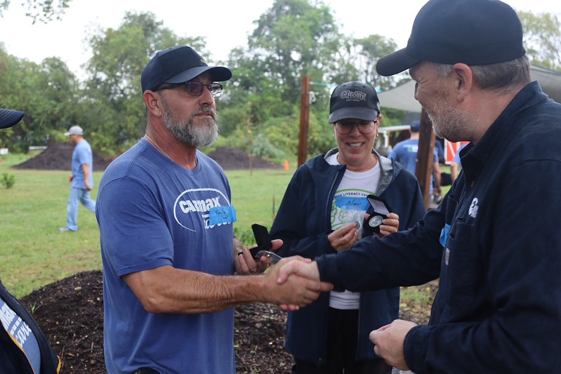 James Gillen, CFRE, Presenting CarMax executives with challenge coin.